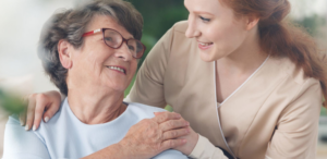 Younger lady, in the background, embracing an older lady, in the foreground